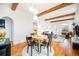 Open concept dining area with hardwood floors and exposed beams at 3403 N Raleigh St, Denver, CO 80212