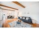 Open living and dining area with hardwood floors and exposed beams at 3403 N Raleigh St, Denver, CO 80212