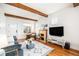 Living room with hardwood floors, fireplace, and exposed beams at 3403 N Raleigh St, Denver, CO 80212