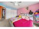 room with vibrant colors, a ceiling fan and a full bed at 10818 Cimarron St # 206, Firestone, CO 80504