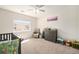 Bedroom room featuring a crib, dresser, chair, and natural light at 10818 Cimarron St # 206, Firestone, CO 80504