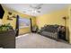 Yellow Bedroom room with crib, window, grey dresser and ceiling fan for a calm and inviting space at 10818 Cimarron St # 206, Firestone, CO 80504