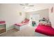 Bright bedroom with twin beds, built-in shelving, and a large window for natural light at 10818 Cimarron St # 206, Firestone, CO 80504