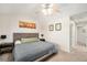 Cozy bedroom featuring a ceiling fan, neutral walls, and a comfortable bed with decorative artwork at 10818 Cimarron St # 206, Firestone, CO 80504
