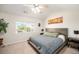Bedroom features a ceiling fan and a window with a view of the neighborhood at 10818 Cimarron St # 206, Firestone, CO 80504