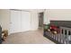 Bedroom room with closet, doorway, and decorated crib at 10818 Cimarron St # 206, Firestone, CO 80504