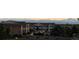 Exterior view of residential buildings with a mountain backdrop and well-maintained landscaping at 10818 Cimarron St # 206, Firestone, CO 80504