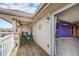 Covered deck with outdoor seating, wood flooring, and views into the home and backyard at 10818 Cimarron St # 206, Firestone, CO 80504