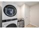 Laundry room with stacked washer and dryer, plus storage racks at 10818 Cimarron St # 206, Firestone, CO 80504