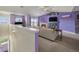 Living room with fireplace and purple accent wall, with sliding doors to the deck at 10818 Cimarron St # 206, Firestone, CO 80504