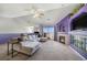 Spacious living room with corner fireplace, sliding glass door and a ceiling fan at 10818 Cimarron St # 206, Firestone, CO 80504