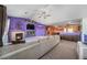 Bright, open living room featuring a fireplace, ceiling fan and adjacent kitchen space at 10818 Cimarron St # 206, Firestone, CO 80504