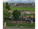 Neighborhood playground with a slide, climbing structure, and mountain views at 10818 Cimarron St # 206, Firestone, CO 80504