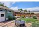 Outdoor patio with a dining set, fire pit, and lush landscaping, perfect for entertaining and relaxation at 3622 Lowell Blvd, Denver, CO 80211