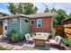 Charming backyard featuring patio seating, a modern fire pit, well-manicured landscaping, and a brick exterior at 3622 Lowell Blvd, Denver, CO 80211