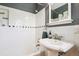 Updated bathroom with classic fixtures, white subway tile, and a shower-tub combination for a spa-like retreat at 3622 Lowell Blvd, Denver, CO 80211