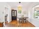 Bright dining room with hardwood floors, modern lighting, and a stylish display cabinet at 3622 Lowell Blvd, Denver, CO 80211