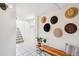 Entryway featuring a cozy bench with decorative hats on the wall, leading to a staircase at 3622 Lowell Blvd, Denver, CO 80211