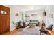 Bright living room featuring a comfortable green sofa, hardwood floors, and ample natural light at 3622 Lowell Blvd, Denver, CO 80211