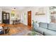 Open-concept living and dining area with hardwood floors, a comfortable sofa, and modern decor at 3622 Lowell Blvd, Denver, CO 80211
