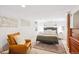 Comfortable main bedroom with neutral decor, a queen bed, and a seating area to create a personal oasis at 3622 Lowell Blvd, Denver, CO 80211