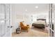 Comfortable main bedroom showcasing natural light, a seating area, a queen bed, and neutral decor for a relaxing retreat at 3622 Lowell Blvd, Denver, CO 80211