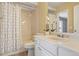 A well-lit bathroom featuring a shower-tub combo, white vanity, and neutral wall tones at 4604 Flanders Way, Denver, CO 80249