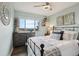 Inviting bedroom with a view, dresser, decorative wall art, ceiling fan, and iron bed frame at 6948 Buckskin Dr, Littleton, CO 80125