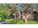 Two-story condo featuring stone accents, a well-maintained lawn, and mature trees offering shade at 1758 S Pitkin Cir # A, Aurora, CO 80017