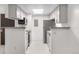 Efficient galley kitchen boasts neutral cabinets, appliances, and abundant countertop prep space at 1758 S Pitkin Cir # A, Aurora, CO 80017