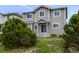 Charming tan two-story home with well-maintained yard and mature landscaping, perfect for outdoor enjoyment at 1416 Red Mica Way, Monument, CO 80132