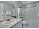 Bathroom featuring a vanity, mirror, recessed lights, and a shower-tub combination with tiled walls and a decorative cabinet at 1416 Red Mica Way, Monument, CO 80132