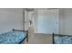 Bright bedroom with twin beds, neutral carpet, closet doors, and an open doorway leading to the landing area at 1416 Red Mica Way, Monument, CO 80132