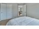 Bedroom with closet, doorway, staircase views, neutral carpet, and a bed with a white comforter at 1416 Red Mica Way, Monument, CO 80132