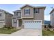 Two-story home with taupe siding, gray shutters, and a two-car garage in a well-maintained neighborhood at 1416 Red Mica Way, Monument, CO 80132