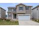 Exterior of a two-story home featuring taupe siding, grey shutters and a two car garage at 1416 Red Mica Way, Monument, CO 80132