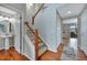 View of the entryway featuring hardwood floors, a staircase, access to a half bath and coat closet at 1416 Red Mica Way, Monument, CO 80132