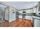 Modern kitchen with stainless steel appliances, white cabinetry, and hardwood flooring at 1416 Red Mica Way, Monument, CO 80132
