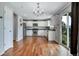 Spacious kitchen with stainless steel appliances, white cabinets and beautiful hardwood floors at 1416 Red Mica Way, Monument, CO 80132