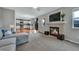 Spacious open-concept living area connects to the kitchen with fireplace and large windows at 1416 Red Mica Way, Monument, CO 80132