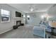 Comfortable living room with a cozy fireplace, bright windows, and plush carpeting at 1416 Red Mica Way, Monument, CO 80132