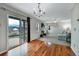 Open-concept living room with hardwood floors leading to a carpeted area with a fireplace at 1416 Red Mica Way, Monument, CO 80132