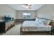 Main bedroom featuring carpet, ceiling fan, a large window, and a mountain themed dresser at 1416 Red Mica Way, Monument, CO 80132