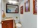 Cozy bathroom features a single sink vanity with a mirror and framed wall art at 8555 Angela Ln, Parker, CO 80134