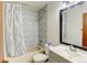 Bathroom featuring a tub-shower, a large mirror and a modern vanity at 8555 Angela Ln, Parker, CO 80134