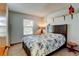 Cozy bedroom with a floral comforter, dark wood headboard and natural light at 8555 Angela Ln, Parker, CO 80134