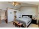 Spacious bedroom with neutral tones, comfortable bed and a view to the ensuite bath at 8555 Angela Ln, Parker, CO 80134