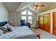 Comfortable bedroom featuring vaulted ceilings, large windows, and a ceiling fan at 8555 Angela Ln, Parker, CO 80134