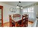 Bright dining room with hardwood floors, classic chandelier, large window with translucent curtains and seating for eight at 8555 Angela Ln, Parker, CO 80134