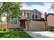 Lovely two-story home with a perfectly manicured front lawn and an attached two-car garage at 8555 Angela Ln, Parker, CO 80134